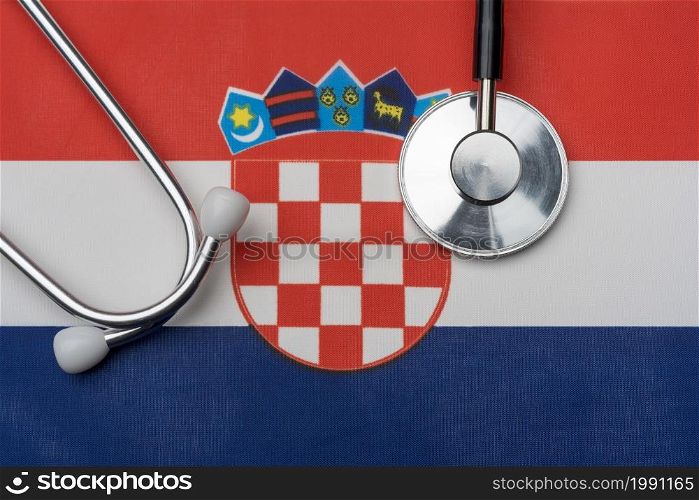 Croatia flag and stethoscope. The concept of medicine. Stethoscope on the flag in the background.. Croatia flag and stethoscope. The concept of medicine.