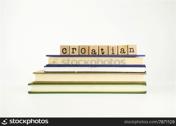 croatian word on wood stamps stack on books, language and conversation concept