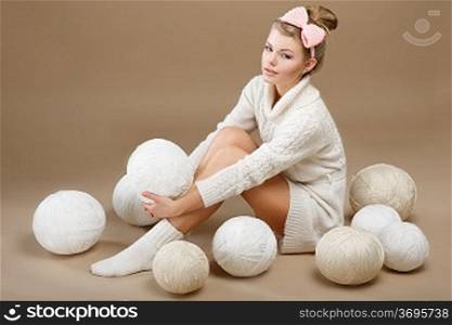 Crochet. Beautiful Needlewoman Sitting with Pile of White Skeins of Yarn. Needlecraft