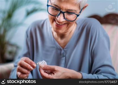 Crochet. Senior woman doing crocheting at home. Cognitive rehabilitation therapy.. Crochet. Senior Woman Doing Crocheting at Home.