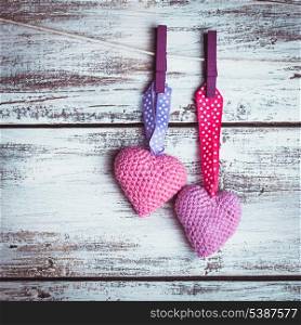 Crochet valentine hearts handing on the rope. Valentine&#39;s day greeting card. Love concept