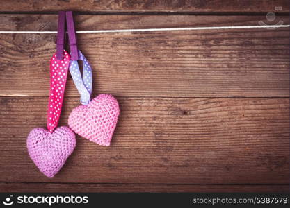 Crochet valentine hearts handing on the rope. Valentine&#39;s day greeting card. Love concept