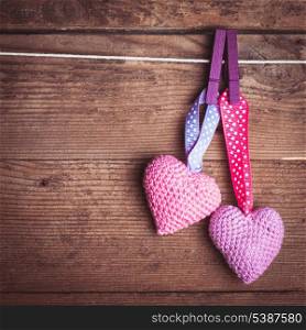 Crochet valentine hearts handing on the rope. Valentine&#39;s day greeting card. Love concept