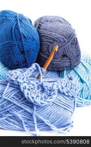 Crocheting pattern with blue a balls of yarn closeup