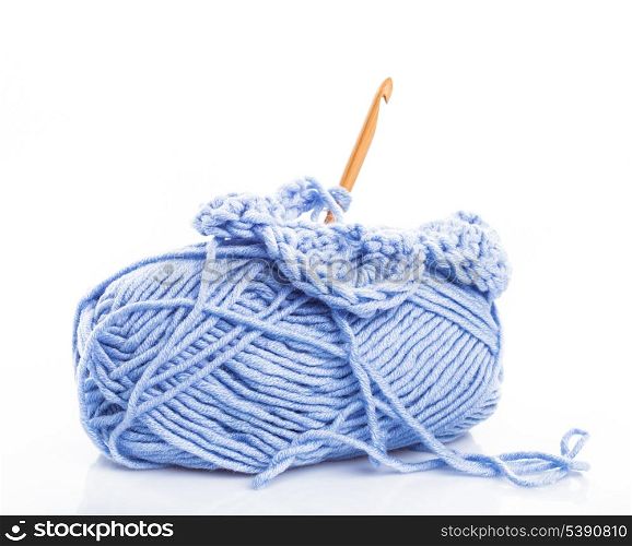 Crocheting with blue threads isolated on white