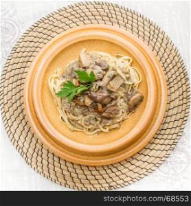 crock dish with tagliatelle and mushrooms