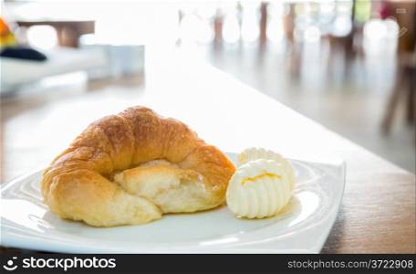 croissant and butter in dish
