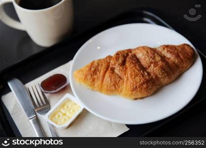 Croissant and coffee in coffee shop