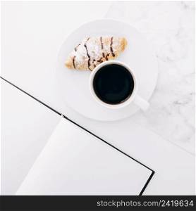 croissant coffee cup plate near blank page notebook