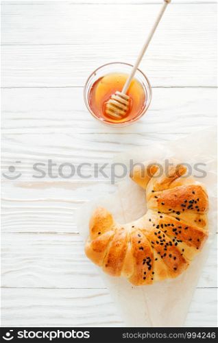 croissant on the white textured wooden background top view, cozy and delicious breakfast. Rustic background.. croissant on the white textured wooden background top view, cozy and delicious breakfast. Rustic background, Vertical image