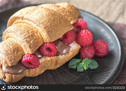 Croissant with chocolate paste and fresh raspberries