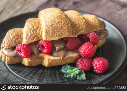 Croissant with chocolate paste and fresh raspberries