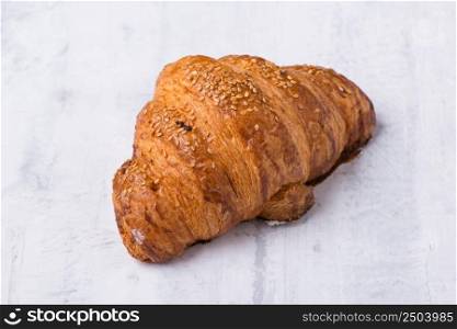 croissant with cream filling on a light background. french croissant on light background