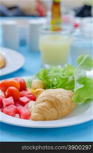 croissant with fruits. A breakfast croissant with mix fruit salad