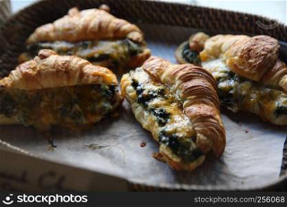croissant with spinach and cheese in basket