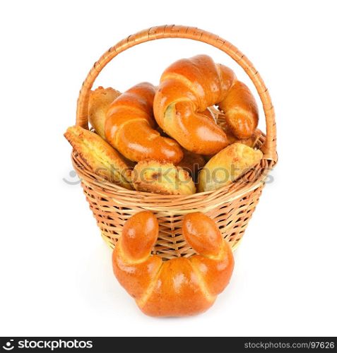 Croissants and cottage cheese rolls in wicker basket isolated on white background.