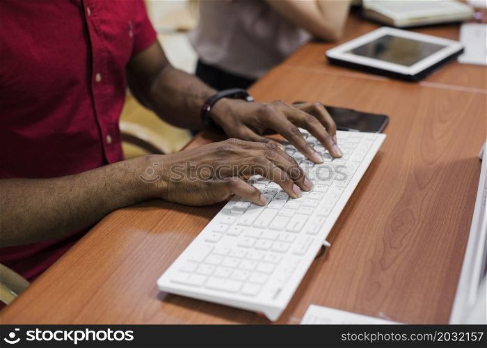 crop black man typing keyboard
