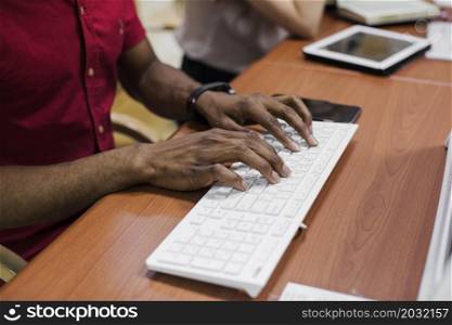 crop black man typing keyboard
