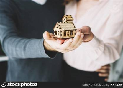 crop couple holding toy house