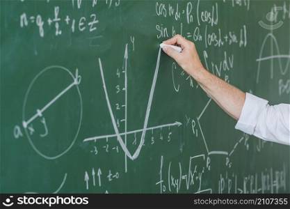 crop hand man chalking graph blackboard