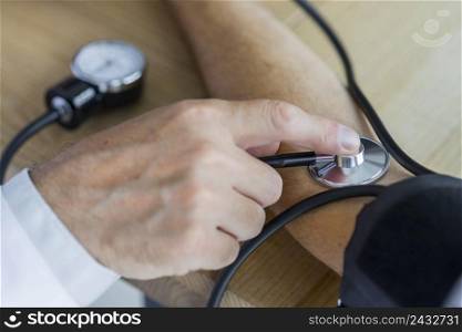 crop hand measuring blood pressure patient