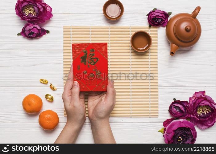 crop hands holding chinese card