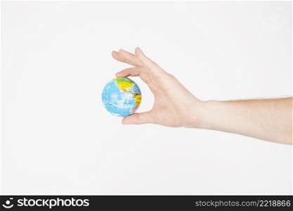 crop hands holding little globe