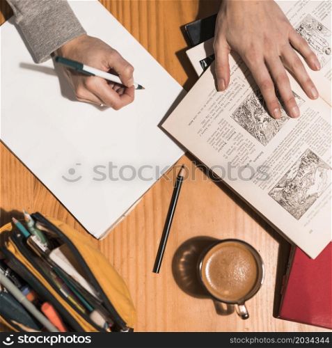 crop hands making notes during studies