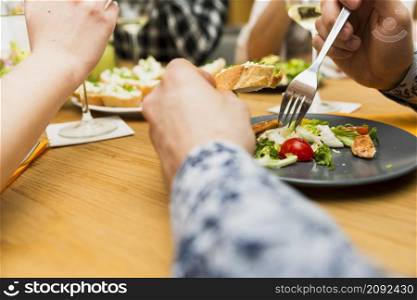 crop hands man eating delicious dish