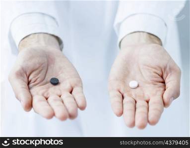 crop hands offering two pills