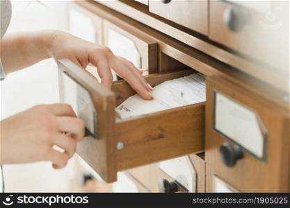 crop hands searching card drawer. Beautiful photo. crop hands searching card drawer