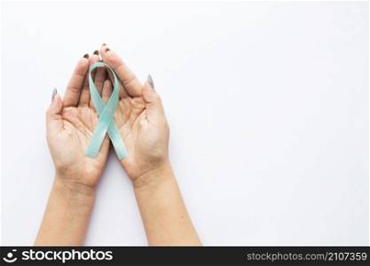 crop hands with light blue ribbon