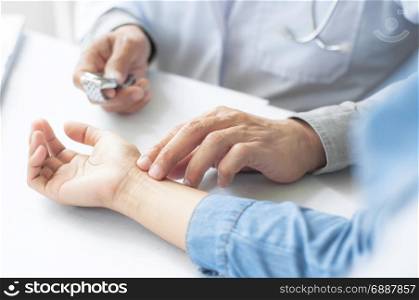 crop image of doctor take the pulse of patient