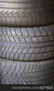 Crop in to three car tyres