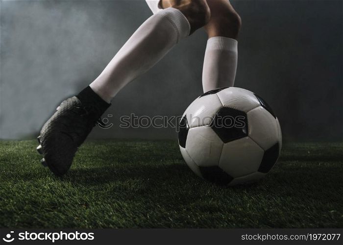 crop legs kicking ball smoke. High resolution photo. crop legs kicking ball smoke. High quality photo