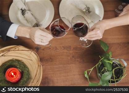 crop loving couple toasting with wine