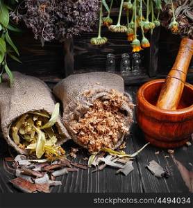 Crop medicinal herb. Dried medicinal herbs and plants in bags of burlap