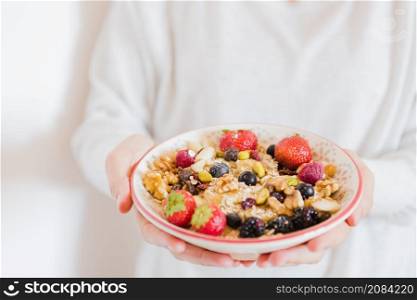 crop person holding bowl oatmeal