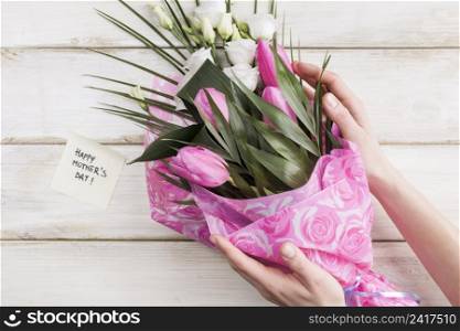 crop woman holding bouquet flowers