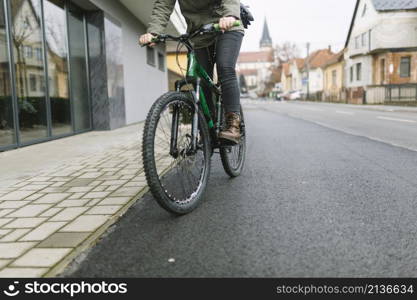 crop woman riding bicycle