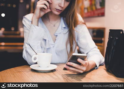 crop woman using smartphone cafe table