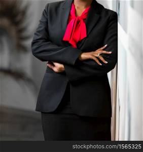 Cropped head African Business Woman in corporate attire with arms folded