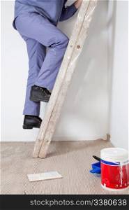 Cropped image of an workman climbing ladder at an apartment