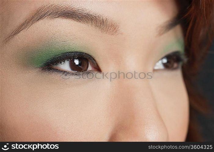 Cropped image of Asian woman looking away