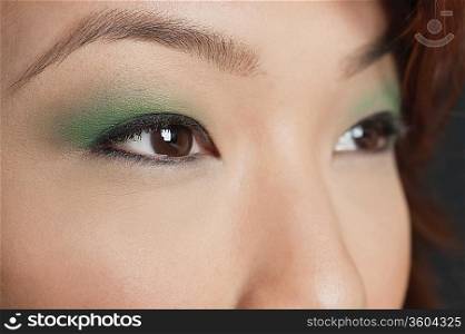 Cropped image of Asian woman looking away
