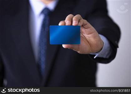 cropped image of businessman showing credit card