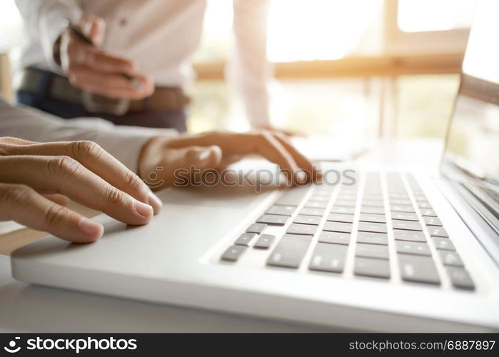 Cropped image of businessmen using laptop for sales performance at a office