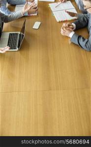 Cropped image of businesspeople discussing at conference table