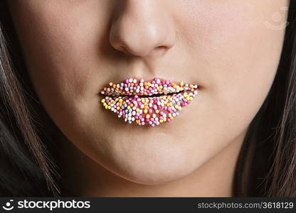 Cropped image of Caucasian woman with sprinkle candy lips