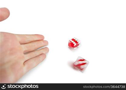 Cropped image of hands throwing gambling dice over white background